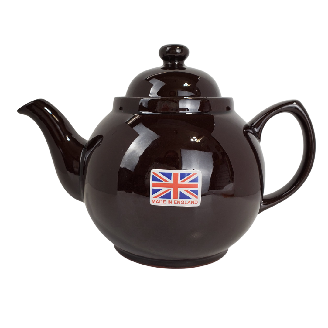 During the reign of Queen Victoria, tea was a symbol of one of the greatest periods in Britain's history. Everyone owned a teapot in this era, many owning the "Brown Betty". Tea was no longer something the upper class could enjoy but became a household staple. This Brown Betty teapot is made from red terracotta and Rockingham glaze. Enjoy your perfect cup of tea without the worry of spiling with the specially designed spout. The Union Jack in the photo is a removable stick