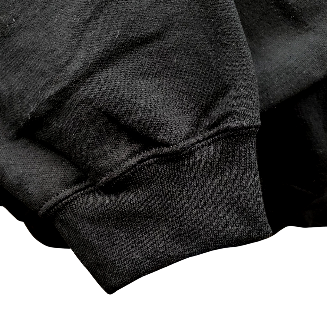 Close up to the sleeve - mBlack crewneck sweatshirt with the England flag embroidered on the left breast with the text "ENGLAND" embroidered in white