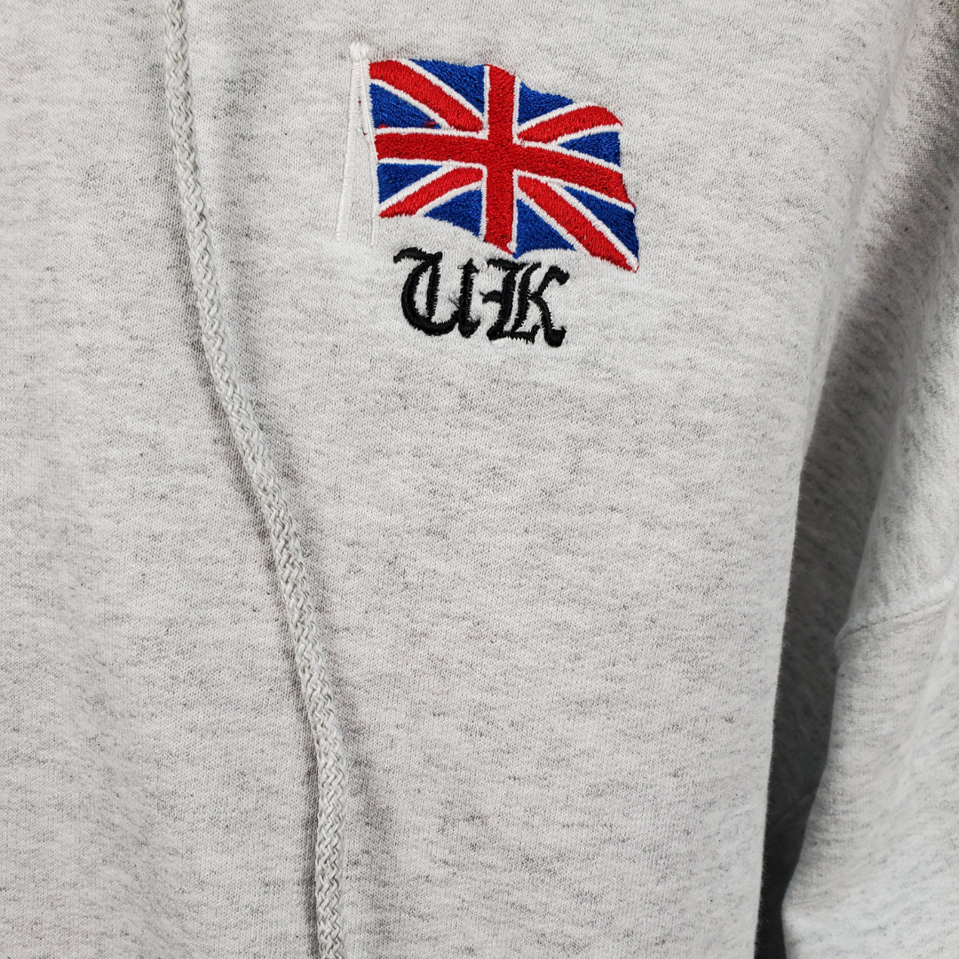 Close up view of Union Jack Flag - The Union Jack is the new black. This soft comfortable hooded sweater is perfect for those cooler nights. Stay cozy while representing your U.K. pride with this embroidered sweater.