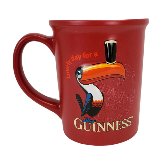 It really is a lovely day when you open your cupboard and see your favourite Guinness mug in the morning. Start your day off right with our Official Guinness mug. This red mug with a picture of a toucan balancing a pint of beer on its beek is sure to put a smile on your face. Care Instructions: Suitable for dishwasher and microwave use.