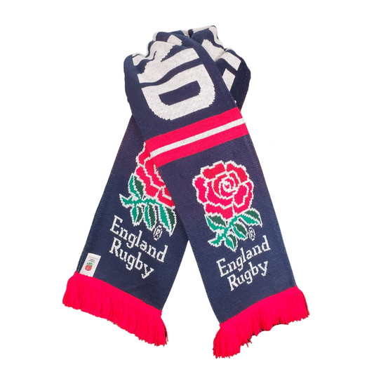 Whether you're cheering from the stands or just need to keep warm in the cold this scarf is ideal. The England Rugby decoration means your pride will be on display wherever you go. This gorgeous knit scarf is perfect for the rugby fan in your life. This scarf features the England rubgy logo at each end and the text "ENGLAND" along the length.