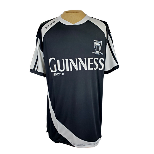 Black Guinness active T-shirt. Has white ribbon pattern down the side and on the arms. The text Guinness spans across the chest in white text.