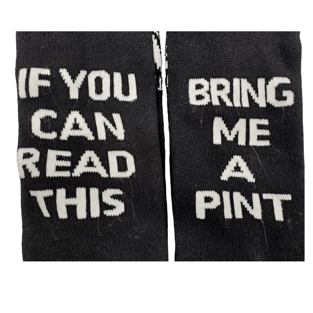 Close up tp wording - Looking to get a fun gift for the beer-lover in your life? Grab these Guinness Official Merchandise socks! These socks are both comfortable and made to last. More importantly, these socks are fun and a real conversation starter. So whether you are looking for a fun Irish gift or to spoil yourself with a pair of premium socks why not pick up a pair today! Guinness Official Merchandise 75% Cotton "If you can read this bring me a pint" Unisex