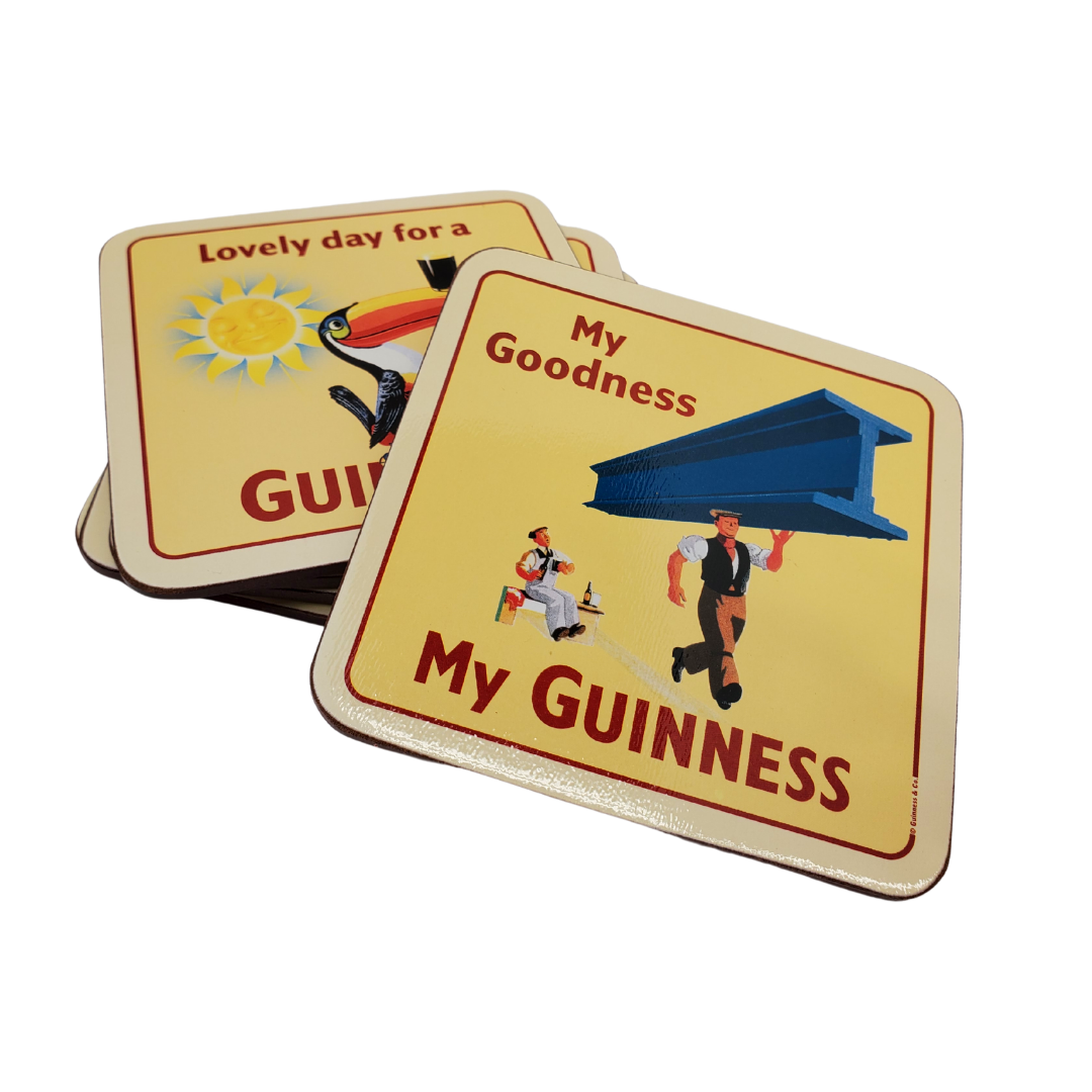 Stack of six Guinness coasters. The one on the top features a man carrying a large steel beam with one arm. And a man sitting in the background with a surprised experssion on his face. The text on the coaster says "My Goodness, My Guinness." The coaster just below it features the iconic Guinness toucan balancing a stout off its beak, with a smiling sun in the background. The text says "Lovely day for a Guinness."