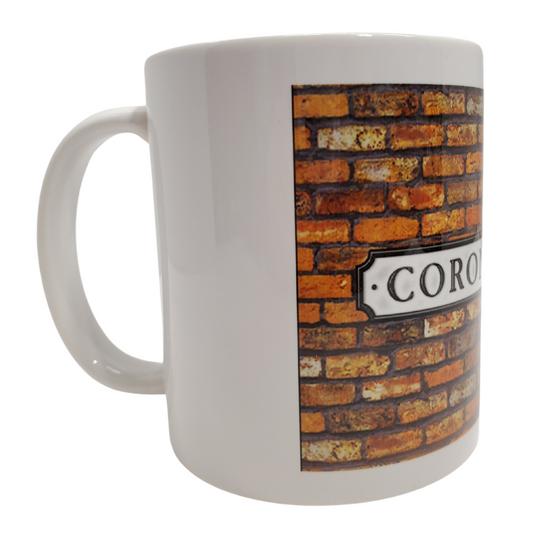 Enjoy your morning brew in our Coronation Street-themed coffee mug. This is the perfect gift for the Coronation Street lover in your life! Features the text "CORONATION ST" on a brick background on a white mug. Standard-sized coffee mug.  You can get a matching magnet for only $2.99 with the purchase of a mug! 
