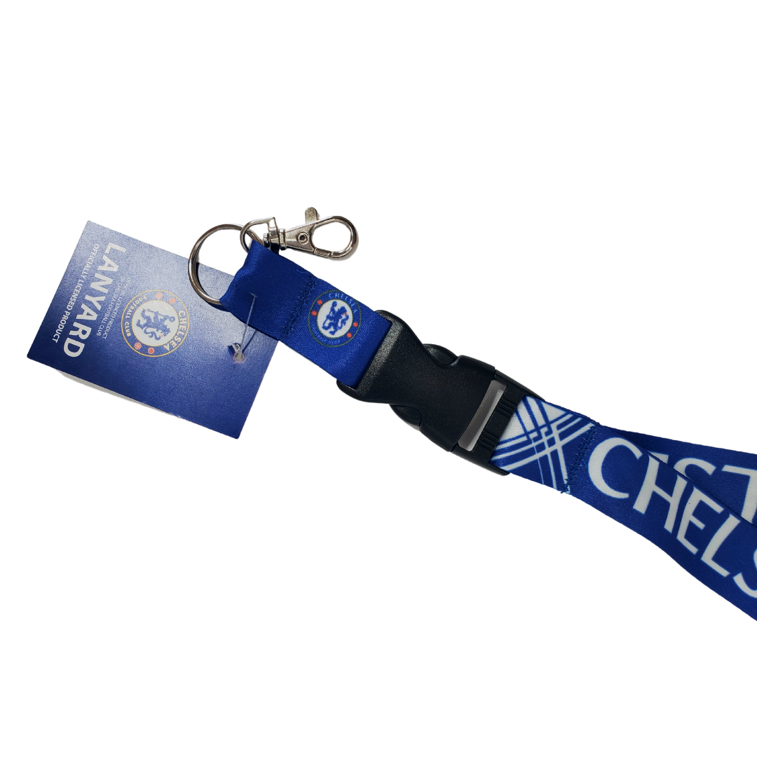 Close up of clasp - Chelsea football club lanyard. Royal b;ue lanyard with the text "CHELSEA" in white and "FC" in a golden yellow. The text wraps around the entire lanyard and between each of the texts written is the official Chelsea logo.