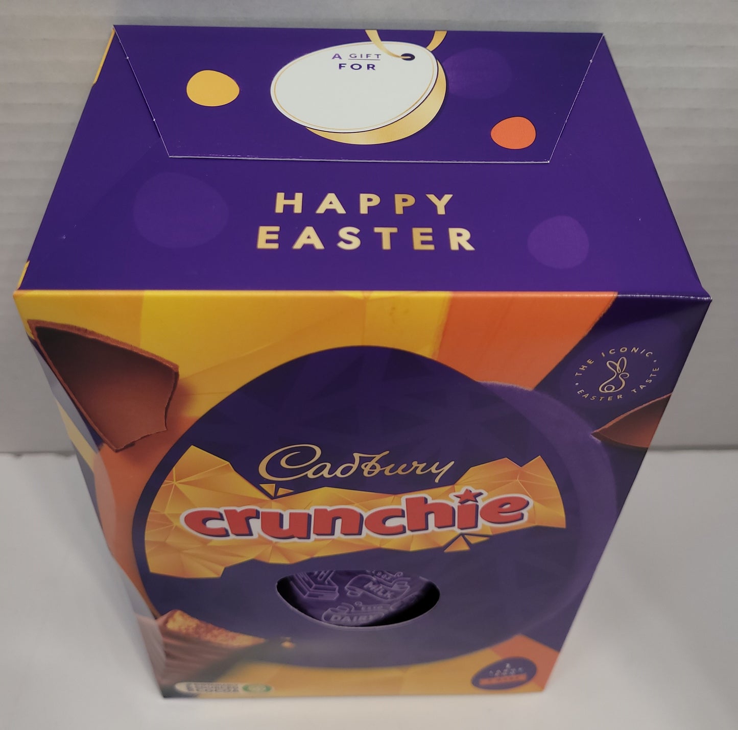 Top view of Box - A hollow chocolate egg made with the world-famous Cadbury Dairy Milk chocolate and filled with two Cadbury Crunchie bars.   Bright festive packaging  perfect for the holiday!    Contents: One hollow chocolate egg and two bars of honeycombed milk chocolate.  Size: 190g.   Imported from the UK