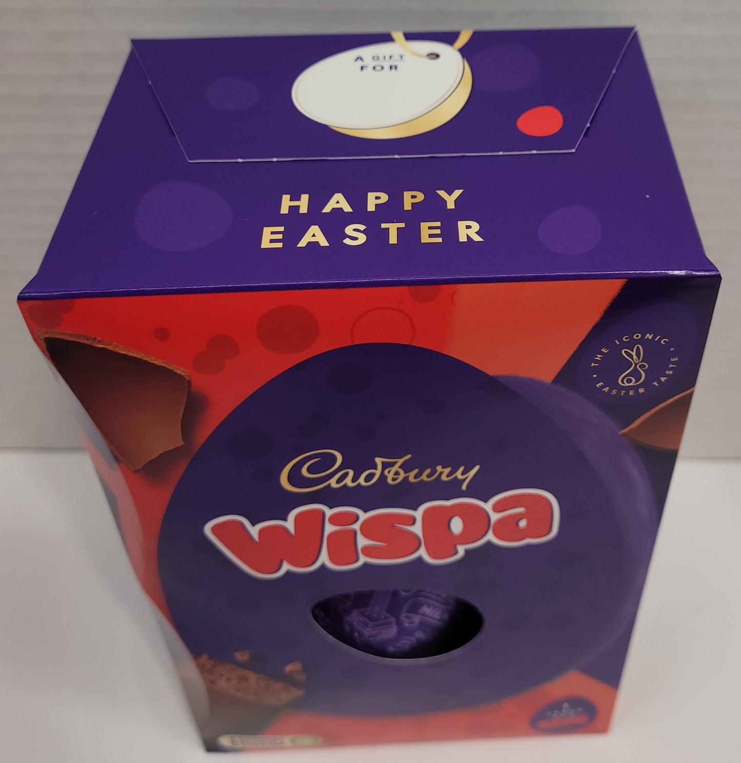 Top view of Box - A yummy hollow chocolate egg made with the world-famous Cadbury Dairy Milk chocolate. The chocolate egg is filled with 1 Cadbury Wispa chocolate bar.   Box contains one Cadbury Dairy Milk hollow chocolate egg and two bars of textured milk chocolate.   152G   Imported from the UK. 