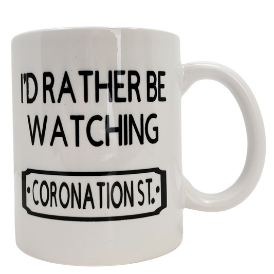 Enjoy your morning brew in our coffee mug. This is the perfect gift for the Coronation Street lover in your life! One side features the text "I'D RATHER BE WATCHING CORONATION STREET" the other side is plain white. Standard-sized coffee mug. 