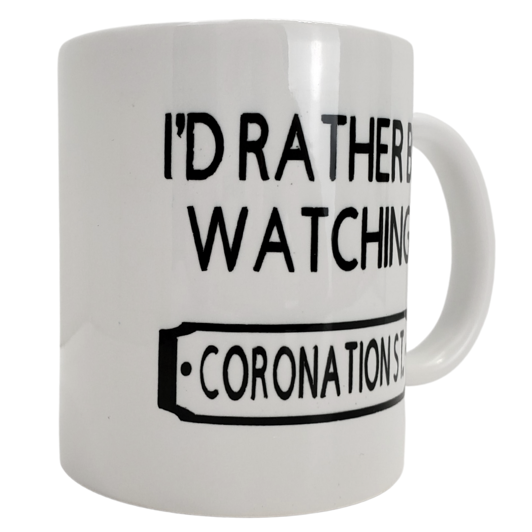 Enjoy your morning brew in our coffee mug. This is the perfect gift for the Coronation Street lover in your life! One side features the text "I'D RATHER BE WATCHING CORONATION STREET" the other side is plain white. Standard-sized coffee mug. 