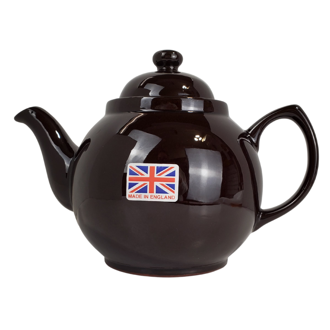 During the reign of Queen Victoria, tea was a symbol of one of the greatest periods in Britain's history. Everyone owned a teapot in this era, many owning the "Brown Betty". Tea was no longer something the upper class could enjoy but became a household staple. This Brown Betty teapot is made from red terracotta and Rockingham glaze. Enjoy your perfect cup of tea without the worry of spiling with the specially designed spout. The Union Jack in the photo is a removable stick