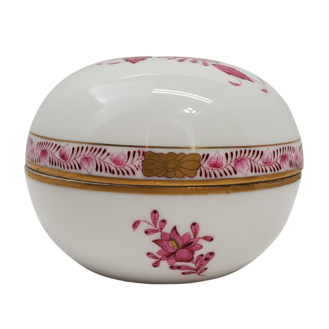 This beautiful Herend Hungary #6032 vintage trinket box is perfect for your vanity. Organize your cotton balls, swabs, or whatever you please. Gorgeous handpainted trinket box with gold touches. Height: 1.46" / 3.7 cm. Diameter: 2.60" / 6.6 cm