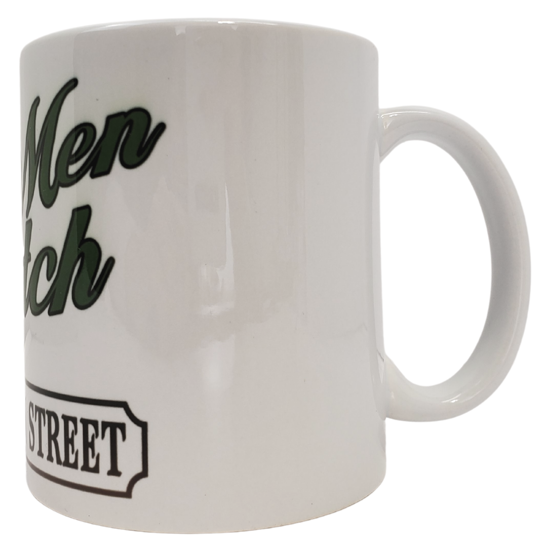 Enjoy your morning brew in our coronation street themed coffee mug. This is the perfect gift for the Coronation Street lover in your life! Features the text "REAL MEN WATCH CORONATION STREET." Standard-sized coffee mug.