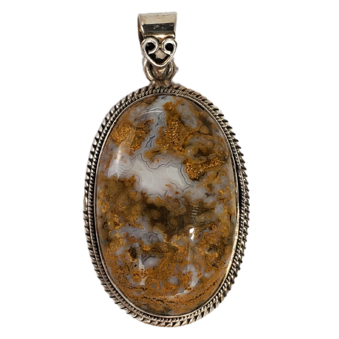 This stunning jasper pendant is wrapped in a twisting sterling silver bezel. This jasper originates from the Canadian Rocky Mountains. The sterling silver contains a cabochon oval shape natural jasper. The pendant measures approximately 2" tall by 1.5" wide. 
