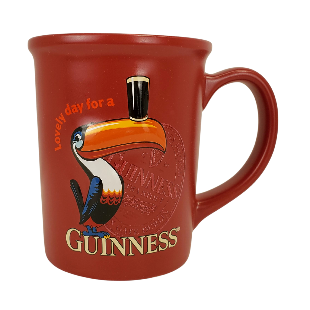 It really is a lovely day when you open your cupboard and see your favourite Guinness mug in the morning. Start your day off right with our Official Guinness mug. This red mug with a picture of a toucan balancing a pint of beer on its beek is sure to put a smile on your face.  Care Instructions: Suitable for dishwasher and microwave use.