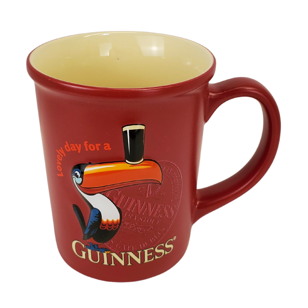 It really is a lovely day when you open your cupboard and see your favourite Guinness mug in the morning. Start your day off right with our Official Guinness mug. This red mug with a picture of a toucan balancing a pint of beer on its beek is sure to put a smile on your face.  Care Instructions: Suitable for dishwasher and microwave use.