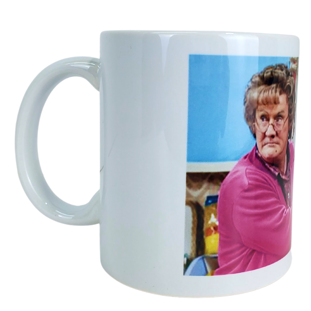 You're going to feckin' love this coffee mug! This coffee mug is perfect for the Mrs.Brown's boys fans! Featuring an image of Mrs.Brown covering the mouth of her counterpart. Standard-sized coffee mug.   EXTRA BONUS: Get the matching magnet for only $2.99 with purchase of mug!