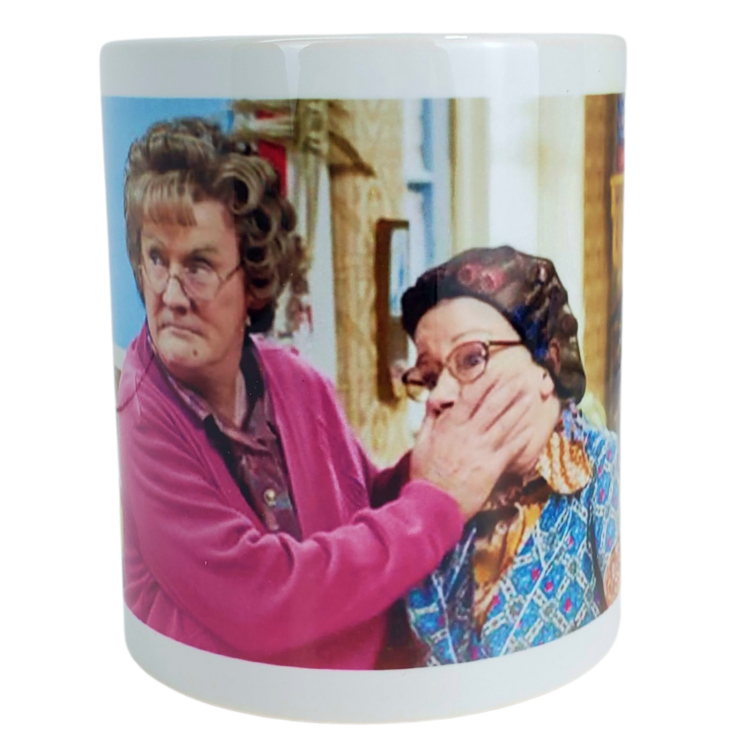 You're going to feckin' love this coffee mug! This coffee mug is perfect for the Mrs.Brown's boys fans! Featuring an image of Mrs.Brown covering the mouth of her counterpart. Standard-sized coffee mug.   EXTRA BONUS: Get the matching magnet for only $2.99 with purchase of mug!