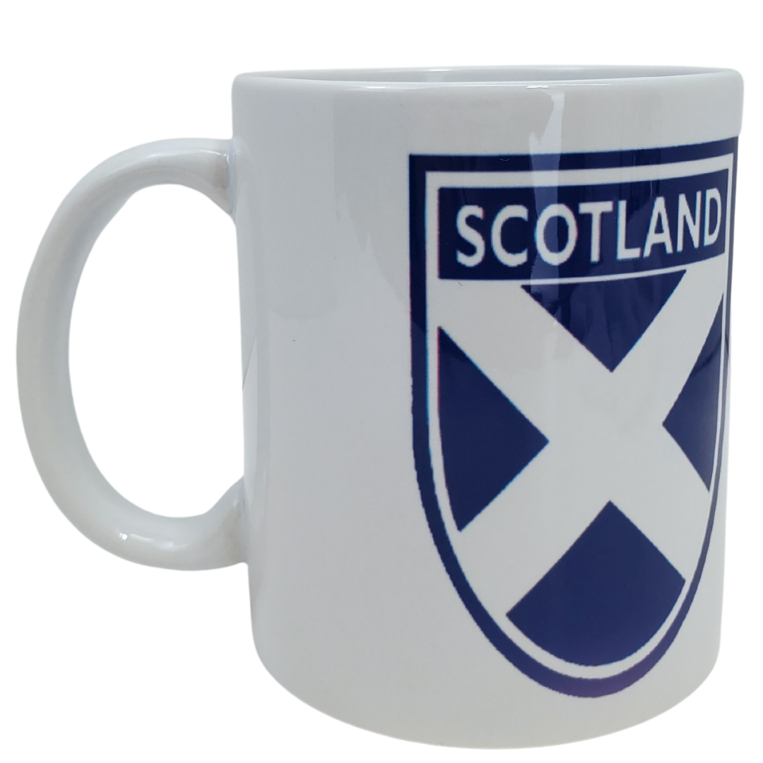 Show off your Scottish pride with our Scottish flag coffee mug. This mug features the Scottish flag in a crest. Features the text "SCOTLAND" in a crest on both sides of the mug along with the Scottish Flag. Standard-sized coffee mug.
