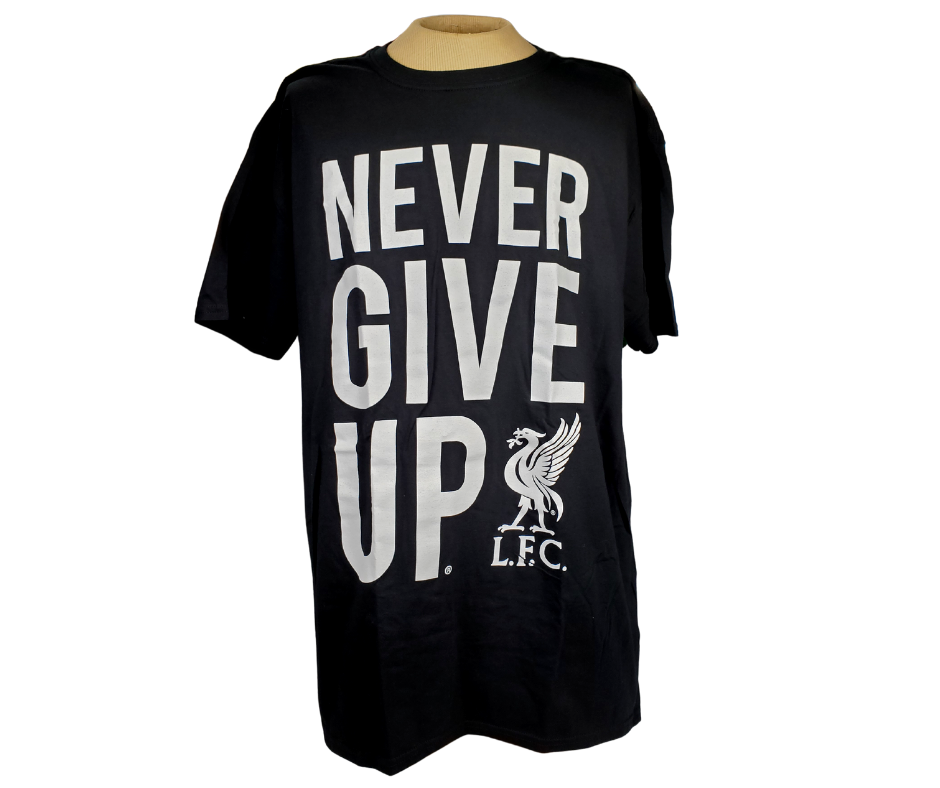 Whether you're cheering from the stands or from your couch this L.F.C. Tee is perfect! This Liverpool tee means your team spirit will be on display no matter where you go. This gorgeous black tee features the text saying "NEVER GIVE UP." alongside the L.F.C. logo.   Material: 100% cotton.  Care Instructions: Machine wash with like colours and inside out. Tumble dry low. Do not iron decoration.