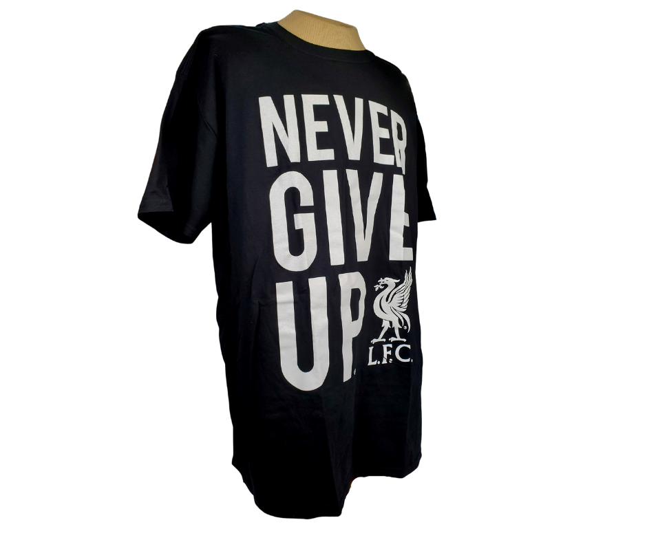 Whether you're cheering from the stands or from your couch this L.F.C. Tee is perfect! This Liverpool tee means your team spirit will be on display no matter where you go. This gorgeous black tee features the text saying "NEVER GIVE UP." alongside the L.F.C. logo.   Material: 100% cotton.  Care Instructions: Machine wash with like colours and inside out. Tumble dry low. Do not iron decoration.