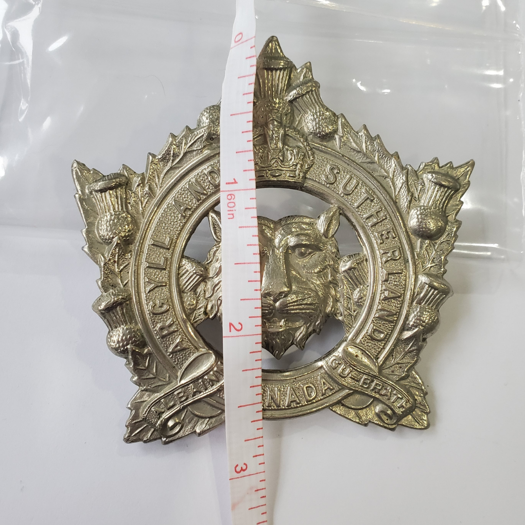 This is from an uncommon unit within the commonwealth army. From the 1930s to 1940s. White metal cap badge. In great condition with complete lugs and pin. - Picture includes a tape measure in from item