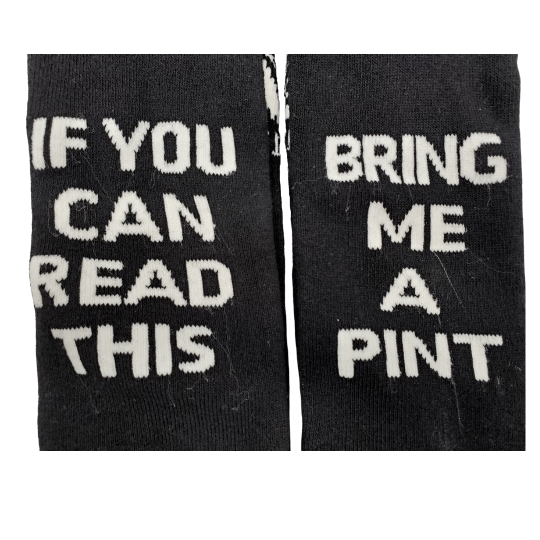 Close up tp wording - Looking to get a fun gift for the beer-lover in your life? Grab these Guinness Official Merchandise socks!  These socks are both comfortable and made to last. More importantly, these socks are fun and a real conversation starter. So whether you are looking for a fun Irish gift or to spoil yourself with a pair of premium socks why not pick up a pair today!  Guinness Official Merchandise 75% Cotton "If you can read this bring me a pint"  Unisex