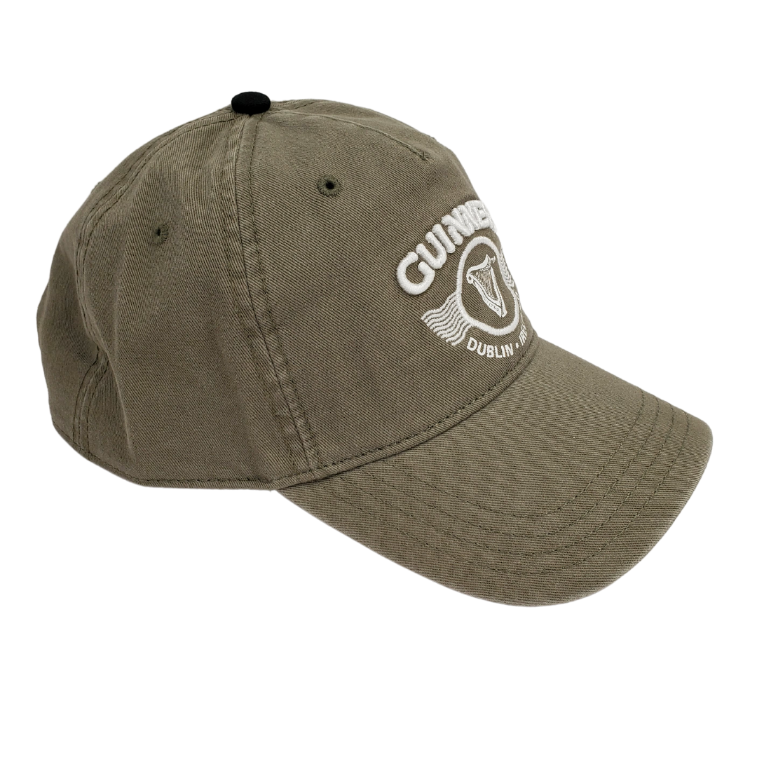 Side view of the army green Guinness ballcap. Has the text "GUINNESS" in the center. Below the text is the famous Guinness harp enclosed in a circle. Below the harp is the text "DUBLIN IRELAND" that curves along the bottom of the circle the harp is enclosed in.