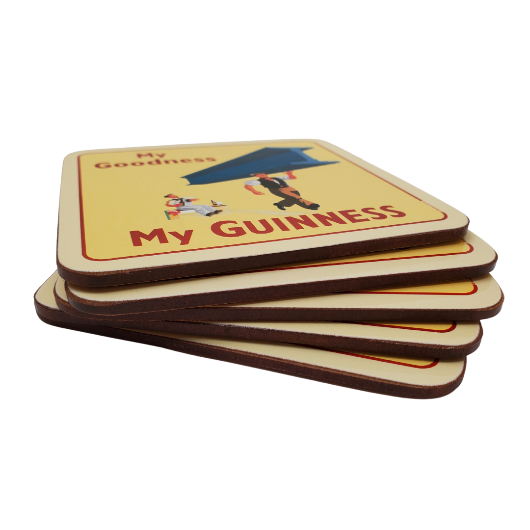 Stack of six Guinness coasters. The one on the top features a man carrying a large steel beam with one arm. And a man sitting in the background with a surprised experssion on his face. The text on the coaster says "My Goodness, My Guinness."